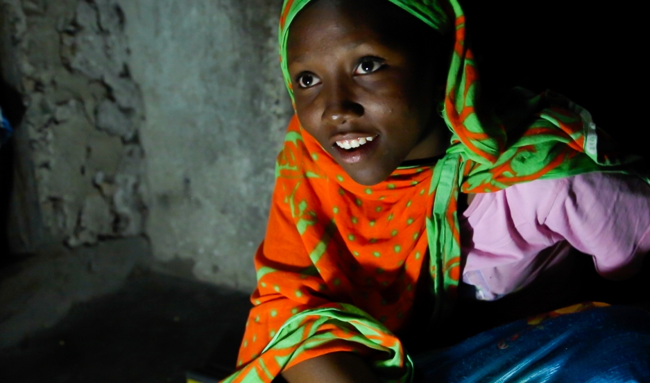 Fourteen year-old Nuru Sheha studies at night in the light of solar-powered LED lights at home in the village of Matemwe, on the Tanzanian island of Zanzibar. He family's first electrical system was installed by one of Zanzibar's 13 "solar mamas," illiterate women trained in India to be solar power engineers. Able now to study at home for the first time, Nuru's mother says she is doing well in school and wants to be a teacher. Since girls are expected to do house chores during daylight hours, night is the only time they can study. She’s doing well in school and dreams of becoming a math and English teacher.