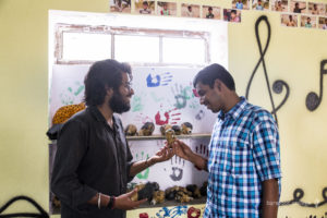 Rajesh being introduced to puppets by Aakash, Education Coordinator